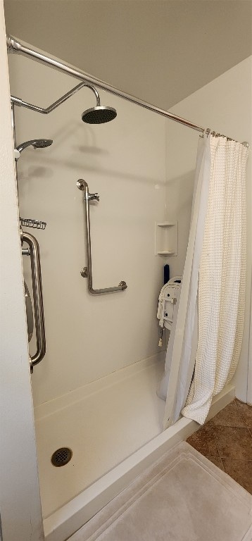 bathroom with curtained shower and tile floors