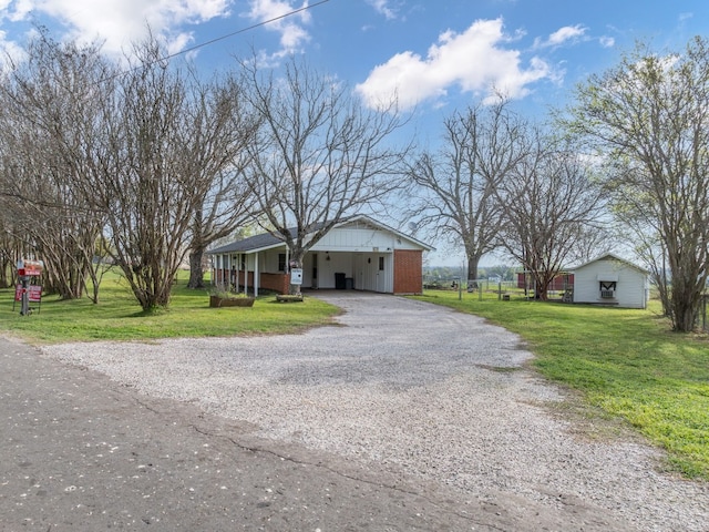 ranch-style house with a carport and a front lawn