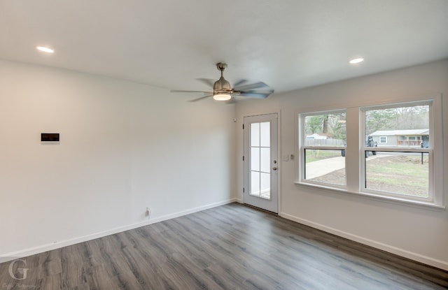 empty room featuring ceiling fan and dark wood-type flooring