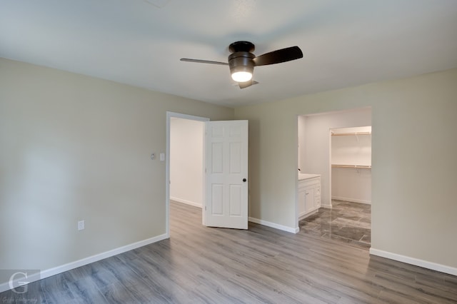 unfurnished room with ceiling fan and light hardwood / wood-style flooring