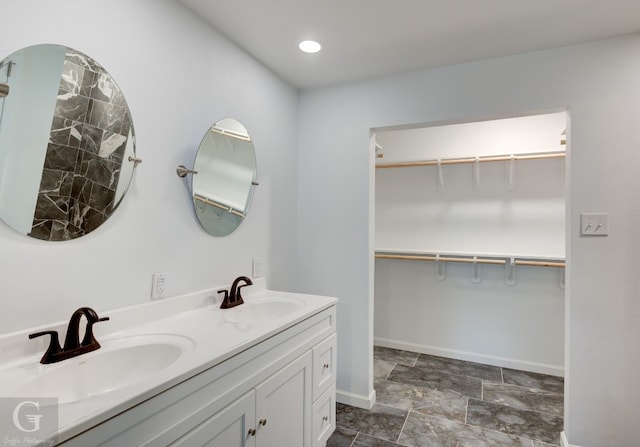 bathroom with double sink, tile floors, and large vanity