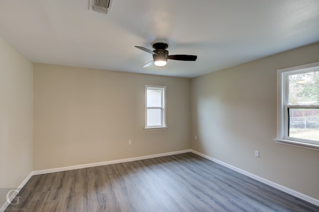 spare room with dark hardwood / wood-style flooring and ceiling fan