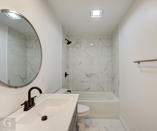 full bathroom with tiled shower / bath, toilet, tile floors, and vanity with extensive cabinet space