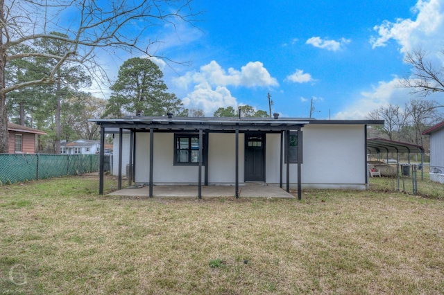 rear view of house with a lawn and a patio