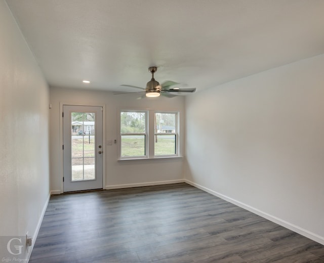 unfurnished room featuring ceiling fan and dark hardwood / wood-style flooring