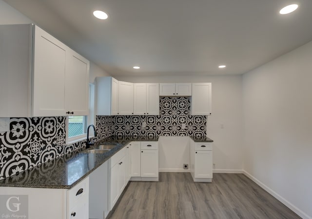 kitchen with white cabinetry, sink, tasteful backsplash, and hardwood / wood-style flooring