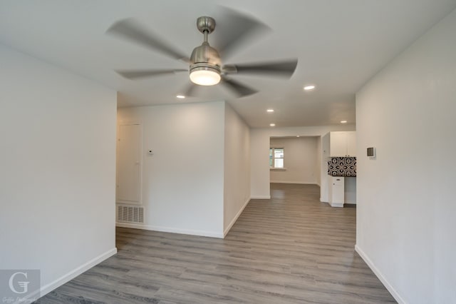 unfurnished room featuring ceiling fan and hardwood / wood-style flooring