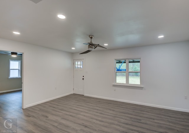 unfurnished room with dark hardwood / wood-style floors and ceiling fan