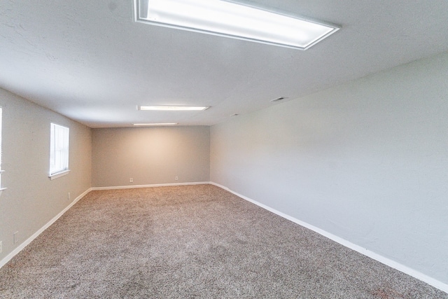 spare room featuring carpet flooring and vaulted ceiling