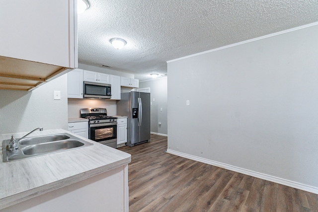 kitchen featuring appliances with stainless steel finishes, dark hardwood / wood-style floors, white cabinetry, and sink