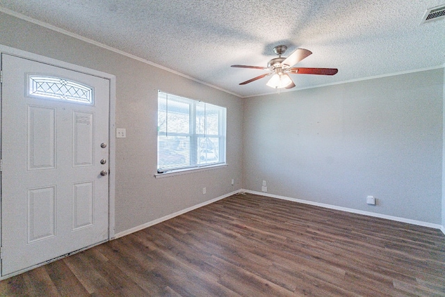 foyer featuring crown molding, ceiling fan, dark wood-type flooring, and a textured ceiling