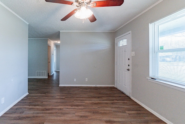 foyer entrance featuring ceiling fan, crown molding, dark wood-type flooring, and a textured ceiling