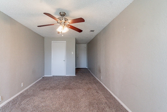 interior space featuring carpet, a textured ceiling, and ceiling fan