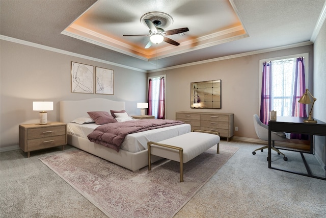 carpeted bedroom with multiple windows, ornamental molding, ceiling fan, and a raised ceiling