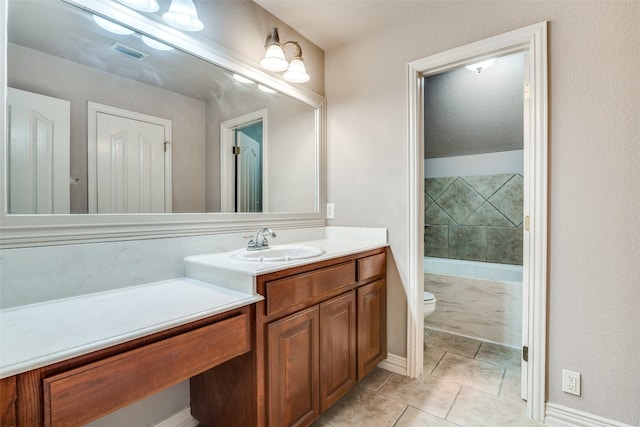 bathroom with a textured ceiling, tile flooring, toilet, and vanity