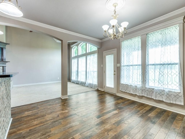 102 Apollo Trl, Aurora, TX 76078 - unfurnished dining area with ornamental molding, hardwood / wood-style flooring, a chandelier, baseboards, and arched walkways