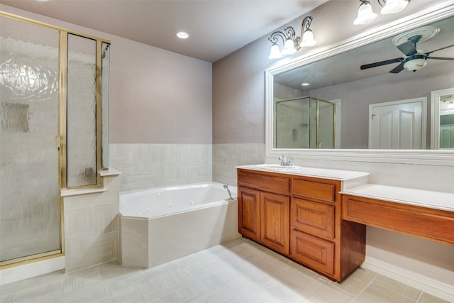 bathroom featuring ceiling fan, separate shower and tub, tile flooring, and vanity with extensive cabinet space