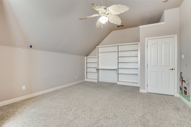 additional living space featuring light colored carpet, vaulted ceiling, and ceiling fan