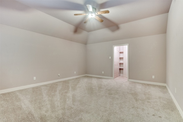 unfurnished room with ceiling fan, lofted ceiling, and light colored carpet