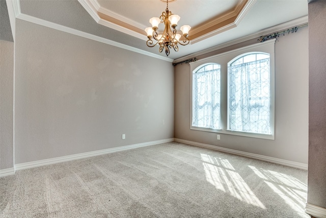 unfurnished room featuring ornamental molding, a raised ceiling, light carpet, and a chandelier