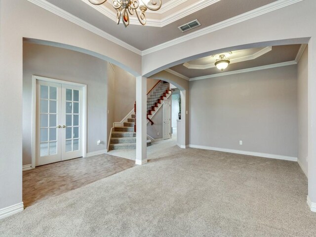102 Apollo Trl, Aurora, TX 76078 - carpeted empty room featuring french doors, arched walkways, stairs, ornamental molding, and a chandelier