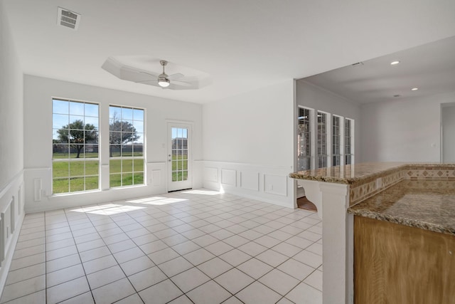 interior space with ceiling fan and ornamental molding