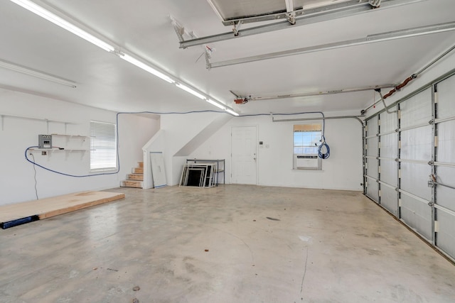 garage with a garage door opener and cooling unit