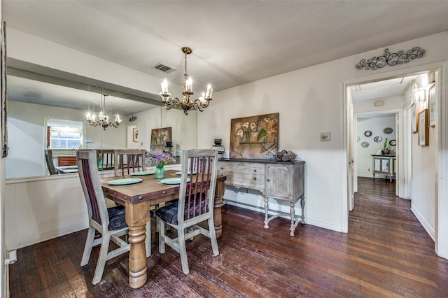 dining area featuring a notable chandelier and dark hardwood / wood-style floors