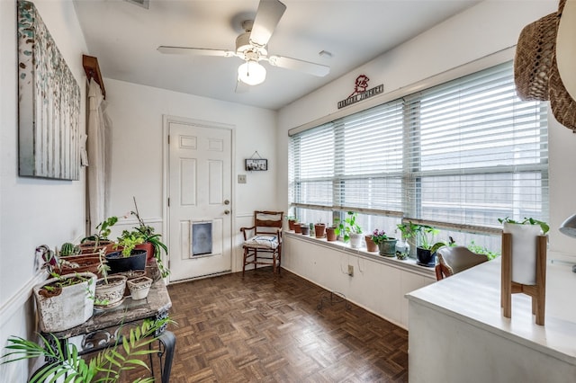 interior space featuring dark parquet flooring and ceiling fan