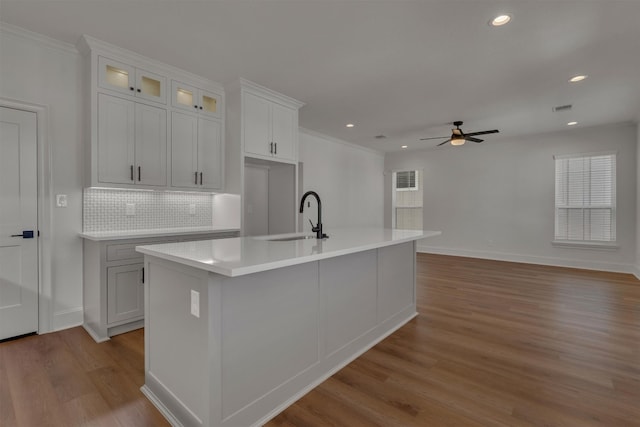 kitchen featuring white cabinets, ceiling fan, sink, and light hardwood / wood-style flooring