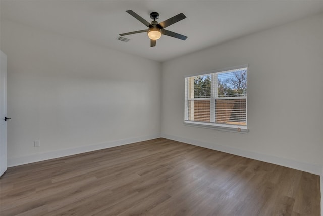 spare room with ceiling fan and light wood-type flooring