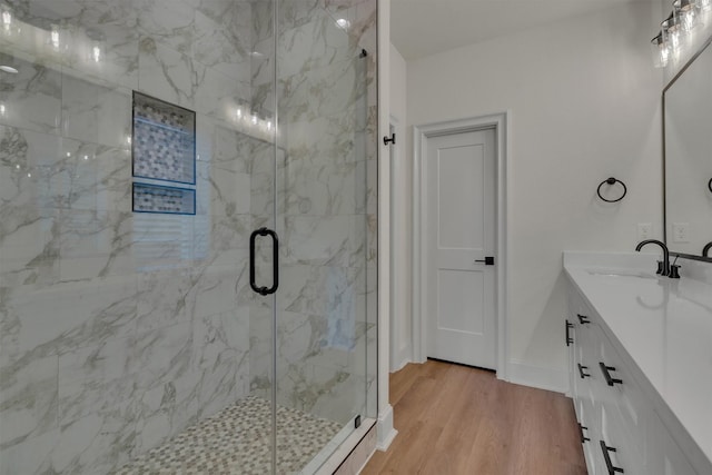 bathroom featuring vanity, a shower with door, and hardwood / wood-style flooring