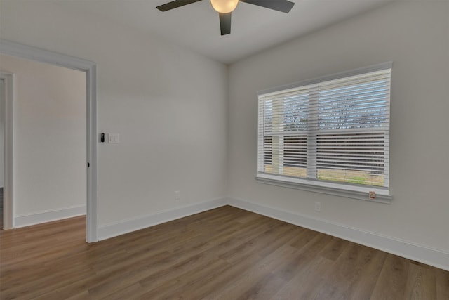 unfurnished room with ceiling fan and dark wood-type flooring