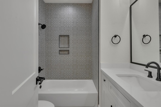 full bathroom featuring vanity, toilet, and tiled shower / bath