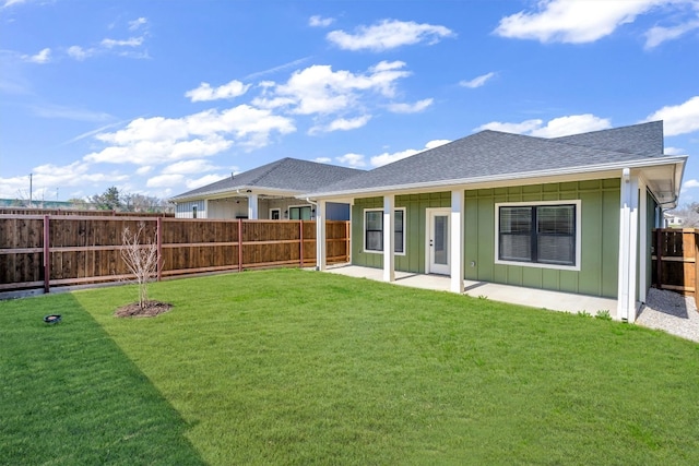 rear view of property featuring a lawn and a patio