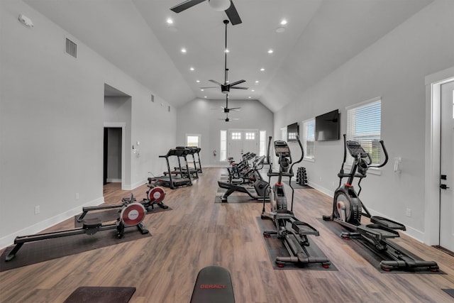 workout room featuring high vaulted ceiling, ceiling fan, and light hardwood / wood-style flooring