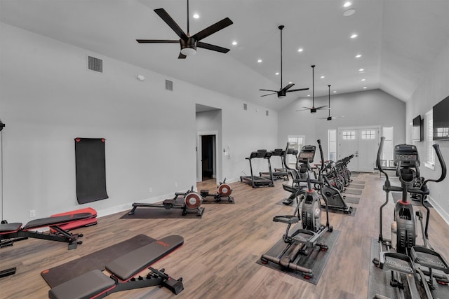 exercise room featuring high vaulted ceiling, ceiling fan, and light hardwood / wood-style flooring