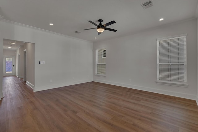 unfurnished room with dark wood-type flooring, crown molding, and ceiling fan