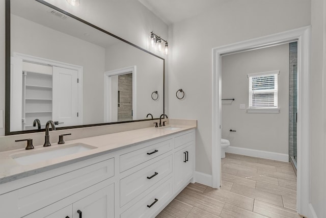 bathroom with double sink vanity, tile floors, and toilet