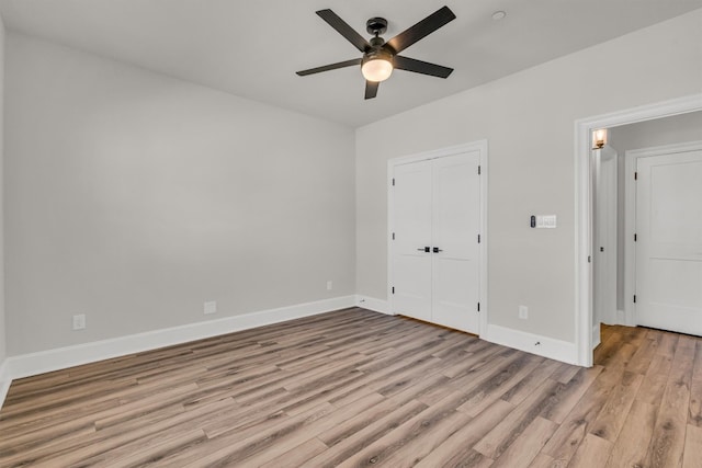 empty room with ceiling fan and light wood-type flooring