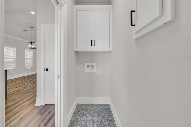 washroom featuring light tile flooring, ornamental molding, a chandelier, and hookup for a washing machine