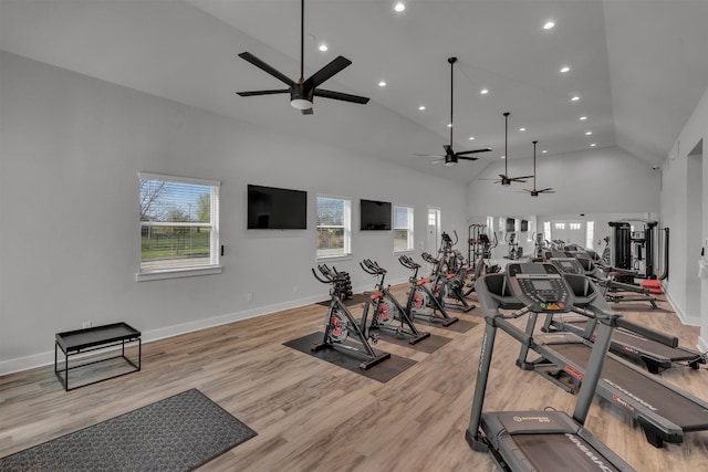 exercise room featuring high vaulted ceiling, light hardwood / wood-style floors, and ceiling fan