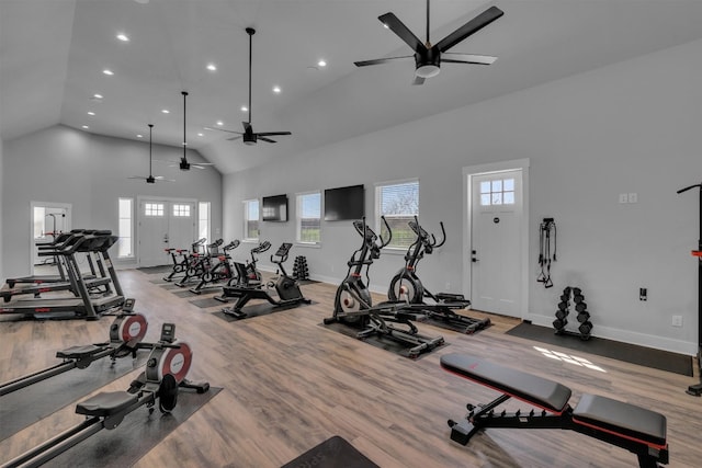 gym featuring high vaulted ceiling, ceiling fan, and light wood-type flooring