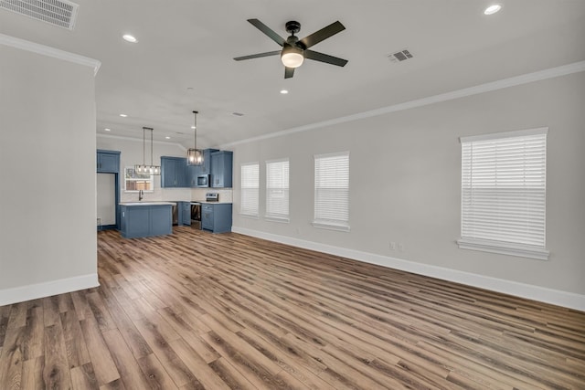 unfurnished living room featuring ceiling fan, crown molding, and hardwood / wood-style floors