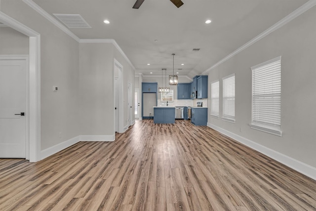 unfurnished living room featuring crown molding, sink, ceiling fan with notable chandelier, and wood-type flooring