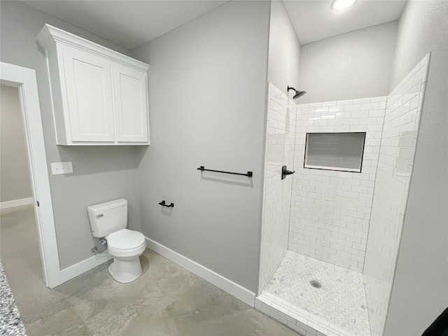 bathroom featuring toilet and tiled shower