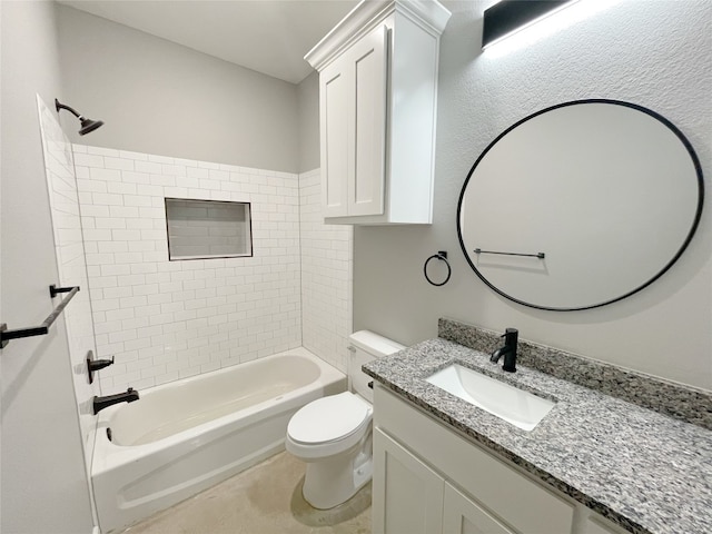 full bathroom featuring toilet, vanity with extensive cabinet space, tile floors, and tiled shower / bath combo