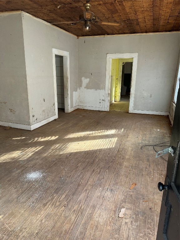 spare room featuring wood ceiling and dark hardwood / wood-style flooring