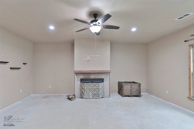 unfurnished living room featuring concrete floors and ceiling fan