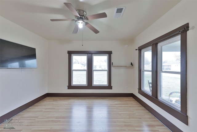 unfurnished room with light hardwood / wood-style flooring, a healthy amount of sunlight, and ceiling fan